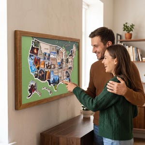 Op de afbeelding: Een rechthoekige wandkaart van de Verenigde Staten met een houten lijst en een groene achtergrond. De kaart is samengesteld uit individuele uitsparingen in de vorm van staten, elk met een unieke foto, met het woord Travel in cursief.