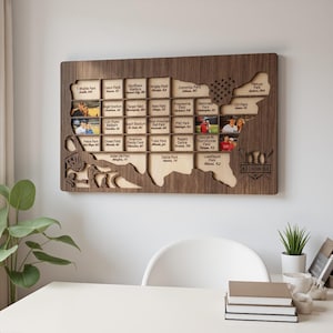 May include: A rectangular wooden wall display shaped like the United States map, featuring a grid of slots for baseball stadium visits. It includes engraved text for various MLB stadiums, small photo inserts, and a baseball and bat logo graphic.