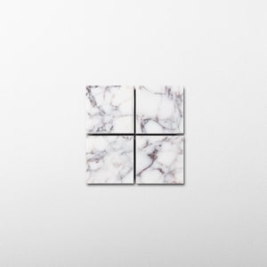 May include: Four square tiles arranged in a grid, each featuring a white base with intricate, dark purple and grey veining patterns that mimic the appearance of natural marble stone, creating a cohesive and repeating decorative surface design.
