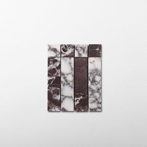 May include: A collection of four rectangular marble tiles arranged in a vertical grid. The tiles feature a mix of deep burgundy and white veined patterns, with some tiles showing more solid dark stone and others displaying intricate white marbling.