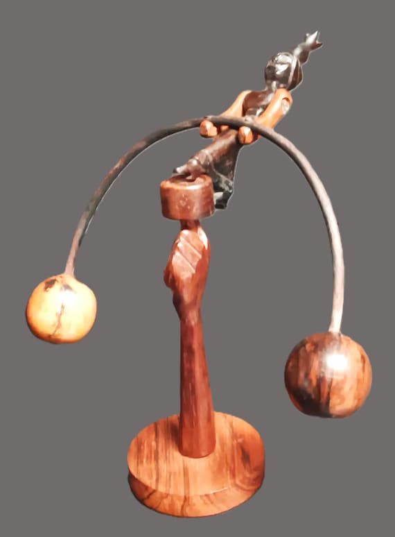 A hand-carved vintage wood kinetic balancing folk sculpture — the kind of lovingly made object that carries real human history in every mark.
