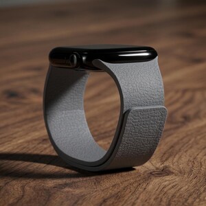 May include: A smartwatch with a glossy black rectangular case and a textured light gray band. The band features a smooth, continuous loop design with a visible overlapping closure mechanism on the side, showcasing a distinct pebbled surface texture.