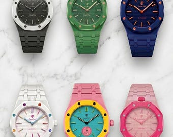May include: Six wristwatches with octagonal bezels and integrated link bracelets. The watches feature various color combinations including black, green, blue, white, pink, and yellow, with textured dials, hour markers, and the AP logo at the top.