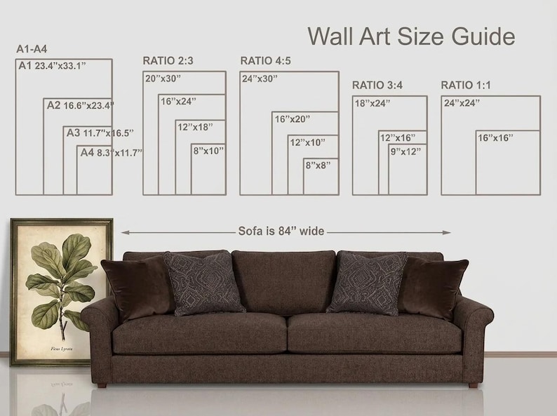 May include: A wall art size guide chart with text and rectangular outlines showing various dimensions in inches, positioned above a brown sofa that is 84 inches wide. To the left, a framed botanical print of a Ficus Lyrata plant is displayed.