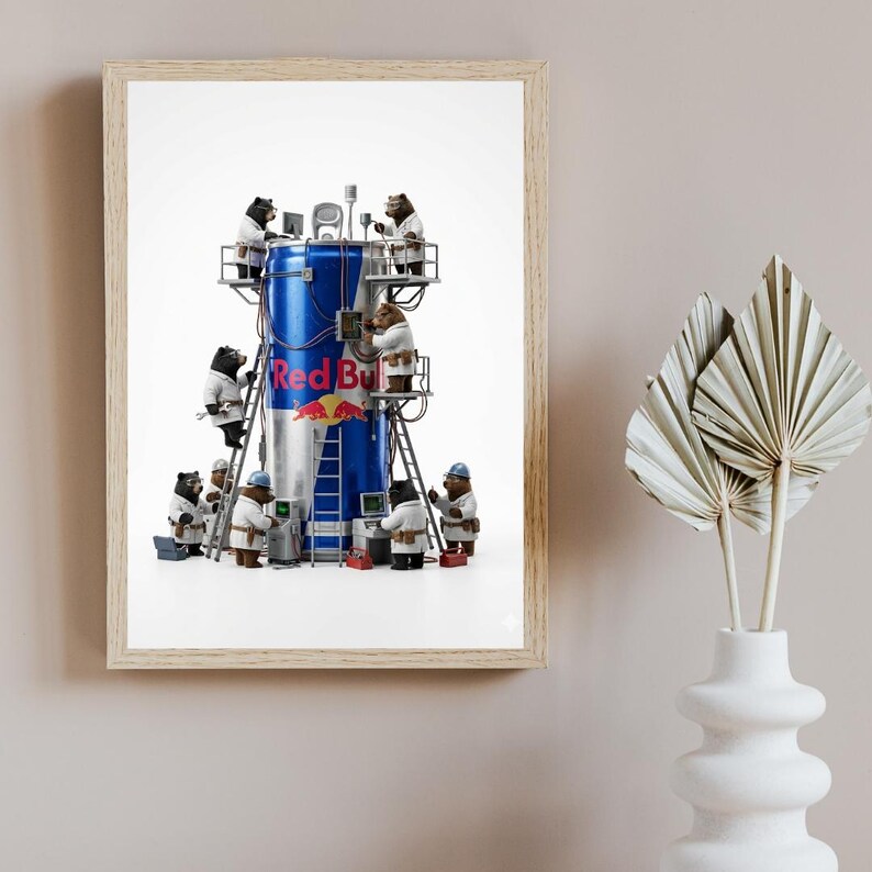 May include: A framed art print featuring a large blue and silver Red Bull can surrounded by several brown bears wearing white lab coats and hard hats. The bears are using tools, ladders, and computers to work on the exterior of the beverage can.
