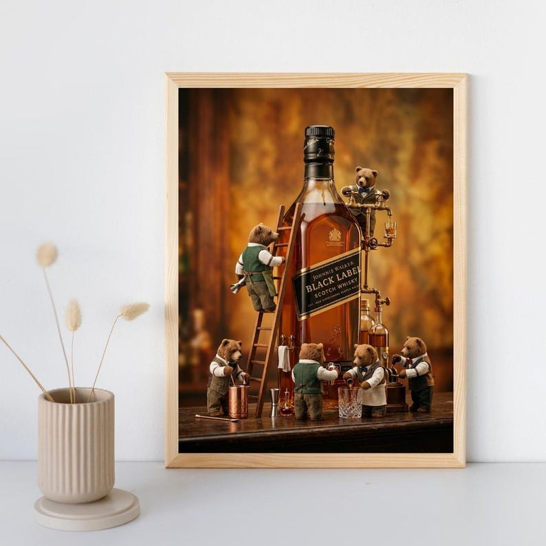 May include: A framed art print featuring a large bottle of Johnnie Walker Black Label Scotch Whisky surrounded by five small, anthropomorphic brown bears wearing vests and bow ties, with one bear climbing a wooden ladder against the bottle.