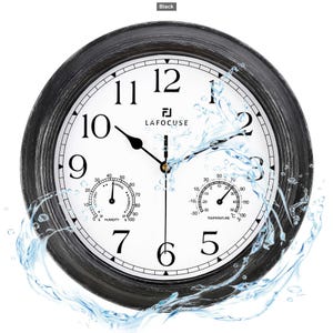 May include: A round black wall clock with a white face, black Arabic numerals, and black hands. The clock features two smaller circular gauges at the bottom for humidity and temperature, with the brand name LAFOCUSE printed in black text.