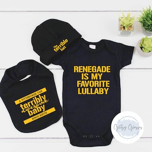 May include: A black baby outfit set with a hat, bib, and onesie. The hat says "The terrible hat." The bib says "A Pittsburgh fan terribly awesome baby since birth." The onesie says "Renegade is my favorite lullaby."