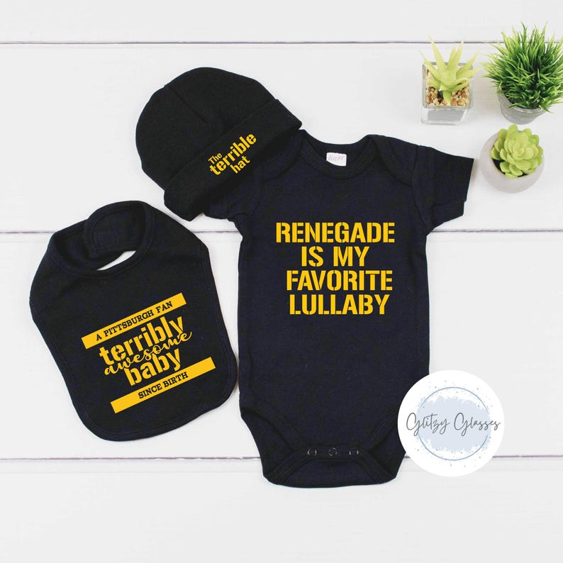 May include: A black baby outfit set with a hat, bib, and onesie. The hat says "The terrible hat." The bib says "A Pittsburgh fan terribly awesome baby since birth." The onesie says "Renegade is my favorite lullaby."