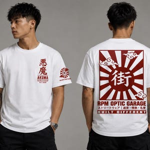 May include: A white short-sleeve t-shirt featuring red graphic prints. The front displays Japanese characters, the word AKUMA, and MOTOR DIVISION. The back features a large red sunburst design with Japanese text, clouds, and RPM OPTIC GARAGE.