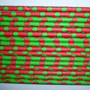 May include: A stack of red and green paper straws with a polka dot pattern. The straws are approximately 7.75 inches long.