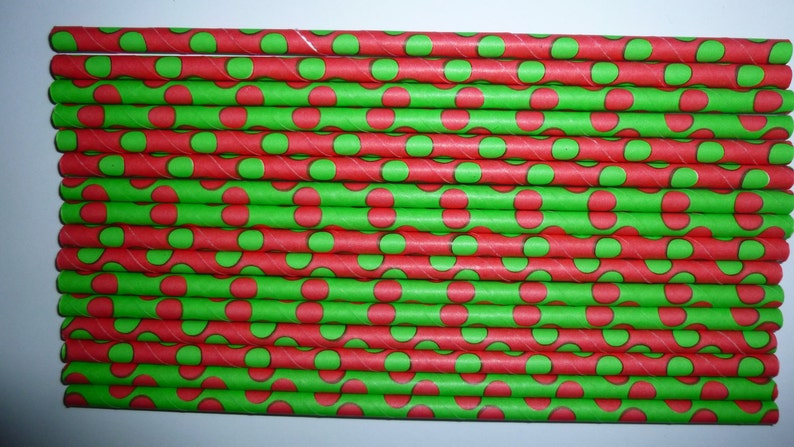 May include: A stack of red and green paper straws with a polka dot pattern. The straws are approximately 7.75 inches long.
