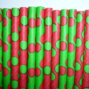 May include: A bundle of red and green paper straws with a polka dot pattern.