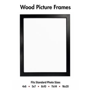 May include: A rectangular black wood picture frame with a white centre. The text at the top reads Wood Picture Frames. The text at the bottom reads Fits Standard Photo Sizes followed by the dimensions 4x6, 5x7, 8x10, 11x14, and 16x20 inches.