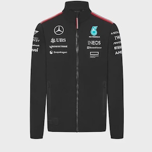 May include: A black zip-up jacket featuring a high collar and long sleeves. The front and sleeves are adorned with various white sponsor logos, including Mercedes, Petronas, Ineos, and TeamViewer, with thin red stripes along the shoulder seams.