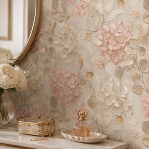 May include: Wallpaper featuring a textured floral pattern with soft pink and cream hydrangea clusters, green leaves, and gold accents on a light beige background. The design includes layered brushstroke effects that create a dimensional appearance.