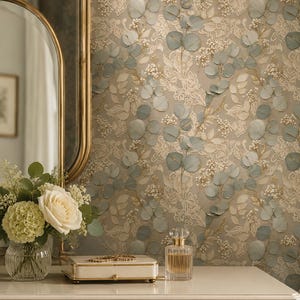 May include: Wallpaper featuring a repeating pattern of sage green eucalyptus leaves, delicate white floral sprigs, and intricate cream-coloured lace motifs set against a soft taupe background, creating a layered botanical and textile design.