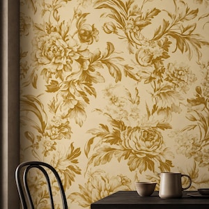 May include: Wallpaper featuring a repeating floral pattern in shades of mustard yellow and cream. The design displays detailed illustrations of large blooming flowers and leafy stems, creating a dense botanical motif across the entire surface.