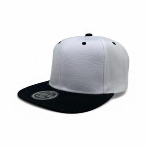 May include: A white snapback cap with a black flat brim and a black top button. The crown features six panels with black eyelets. A circular sticker on the brim displays the text BASIC CAP SNAPBACK in white lettering against a black background.
