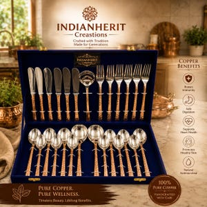 May include: A flatware set in a dark blue storage box, featuring copper-toned hammered handles and silver-toned heads. The set includes knives, forks, spoons, and a ladle. Text on the box reads INDIANHERIT Creations and Pure Copper. Pure Wellness.