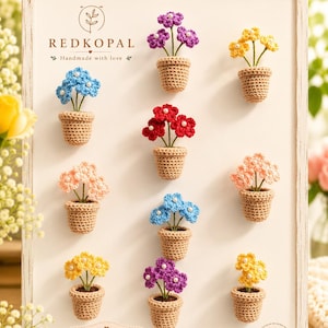 May include: A collection of ten crocheted flower pot magnets displayed on a white board. Each magnet features a small tan crocheted pot with colorful flowers in purple, yellow, blue, red, and peach, each accented with a tiny white center bead.