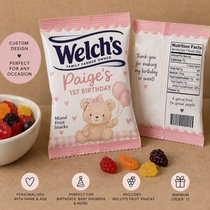 May include: Two custom Welch's mixed fruit snack pouches with pink and white packaging. The front features a teddy bear, two balloons, and the text 'Paige's 1st Birthday'. The back displays nutrition facts for a 22g serving size and a barcode.