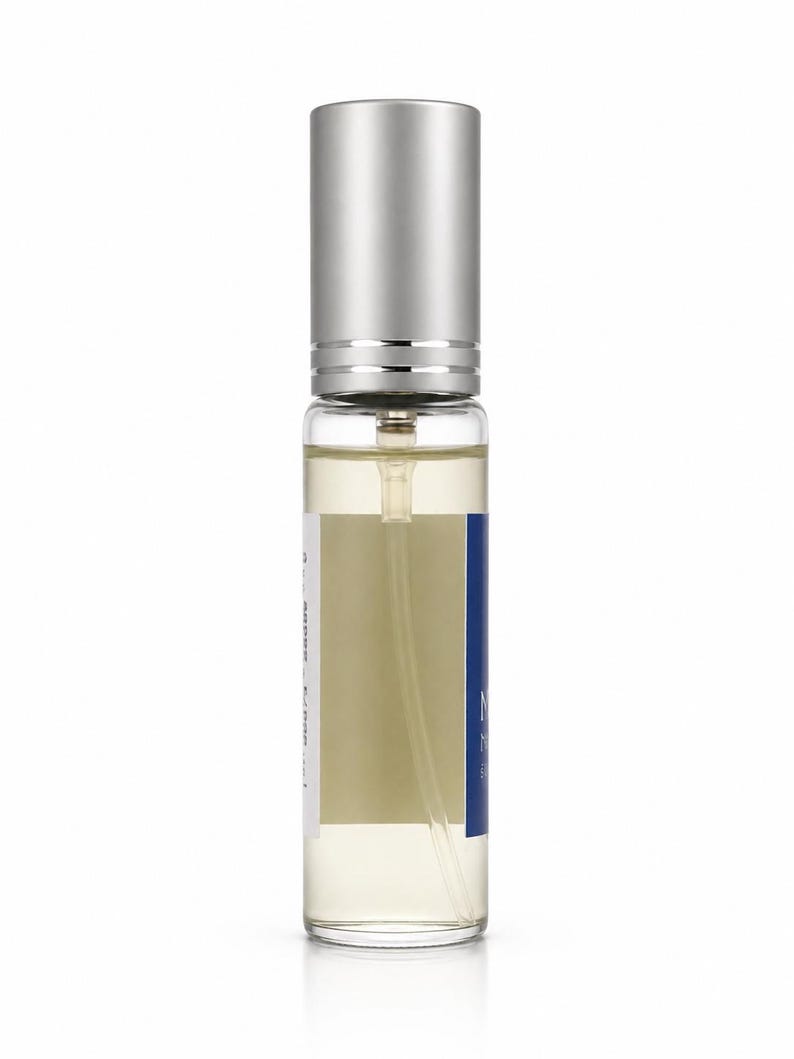 Manifesting 15ml discovery eau de parfum translucent glass front view with dark cobalt blue label — Maison Voyageur Mediterranean artisanal parfumerie Madrid unisex