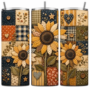 May include: A cylindrical tumbler with a straw featuring a patchwork design of sunflowers, hearts, stars, and buttons. The pattern includes various fabric textures in shades of navy blue, mustard yellow, orange, and cream with floral motifs.