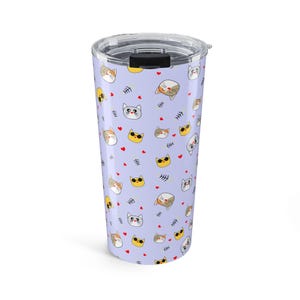 May include: A light purple stainless steel tumbler featuring a repeating pattern of various cartoon cat faces, small red hearts, and fish bone skeletons. The drinkware includes a clear, removable plastic lid with a black sliding closure mechanism.