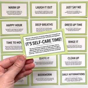 May include: A set of 12 green cards with self-care ideas written on them. The cards are laid out in a grid pattern. The card in the center is larger than the others and has the text "It's Self-Care Time!" written on it. The text on the other cards includes phrases like "Laugh it Out", "Just Say No", "Happy Hour", "Deep Breaths", "Dress Up Time", "Time to Move", "Binge It", "Quote It", "Clean Up", "Bookworm", and "Daily Affirmations".