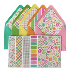 May include: A set of five rectangular greeting cards and matching envelopes in green, yellow, orange, and pink. The stationery features colourful patterns including small floral prints, diagonal plaid, thin grid lines, and horizontal stripes.