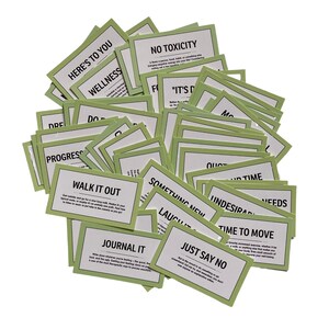 May include: A pile of green cards with motivational phrases like "Walk it Out", "Journal It", "Just Say No", "Time to Move", "Something New", "No Toxicity", "It's Done", and "Here's to You".