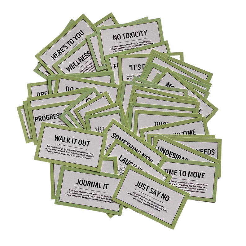 May include: A pile of green cards with motivational phrases like "Walk it Out", "Journal It", "Just Say No", "Time to Move", "Something New", "No Toxicity", "It's Done", and "Here's to You".