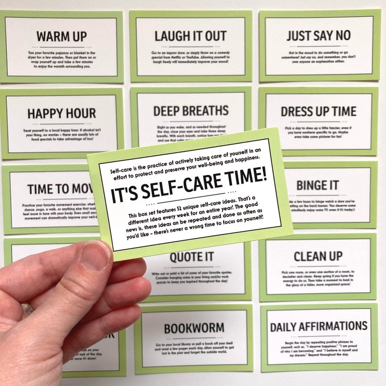 May include: A set of 12 green cards with self-care ideas written on them. The cards are laid out in a grid pattern. The card in the center is larger than the others and has the text "It's Self-Care Time!" written on it. The text on the other cards includes phrases like "Laugh it Out", "Just Say No", "Happy Hour", "Deep Breaths", "Dress Up Time", "Time to Move", "Binge It", "Quote It", "Clean Up", "Bookworm", and "Daily Affirmations".