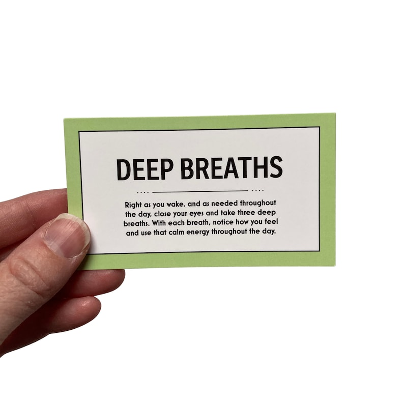 May include: A green card with the text "DEEP BREATHS" in black. The card has instructions for taking deep breaths to calm down and use that energy throughout the day.