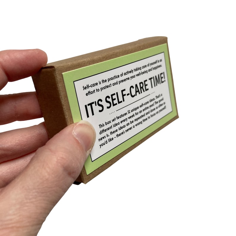 May include: A brown box with a green label that reads "IT'S SELF-CARE TIME!"  The label also includes the text "Self-care is the practice of actively taking care of yourself is an effort to protect and preserve your well-being and happiness."  This box set features 52 unique self-care ideas. That different idea every week for an entire year The good news is, these ideas can be repeated and done as often as you'd like - there's never a wrong time to focus on yourself.