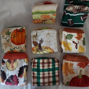 May include: Set of ten kitchen towels with various fall-themed designs. The towels feature pumpkins, leaves, turkeys, and plaid patterns. Some towels have crocheted trim.