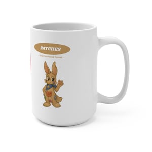May include: White ceramic mug featuring a cartoon rabbit character named "Patches" with a blue bandana and patches on its body. The mug has the text "Patches - The Patchwork Forest" in a brown oval.