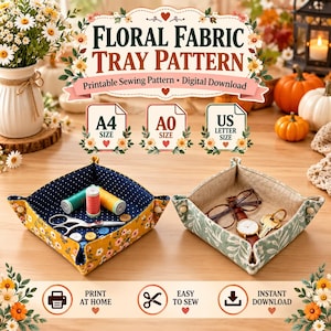 May include: Two square fabric trays with snap corners. The left tray is yellow with white flowers and a navy blue polka dot interior, holding sewing supplies. The right tray is sage green with white leaf patterns, holding glasses, a watch, and keys.