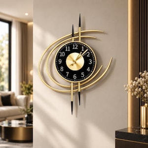 May include: A wall clock featuring a circular black face with gold numerals and a central gold disc. The clock is surrounded by curved gold metal arcs and vertical gold rods with black pointed tips, creating an asymmetrical, layered design.