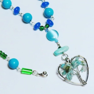 Tree of Life pendant necklace. Original handmade jewelry designs.  Necklace with blue gemstone and glass beads with tree of life pendant.