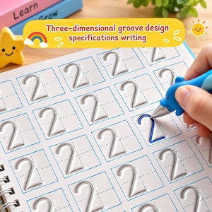 May include: A white practice workbook featuring a grid of embossed number two shapes with a three-dimensional groove design. A blue dolphin-shaped pen is tracing one of the grooves. The page includes the text Three-dimensional groove design specifications writing.