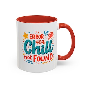 May include: A white ceramic mug with a bright red interior and handle. The exterior features a colorful graphic with the text "ERROR 404: Chill not FOUND" in blue and red, surrounded by small decorative shapes like stars and abstract squiggles.