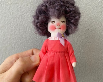 Handmade smiling doll with her pet