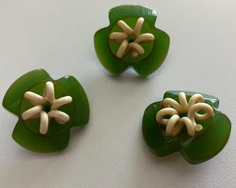 Three Art Deco green buttons