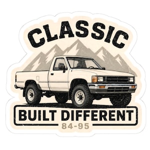 May include: A sticker featuring a white pickup truck with black tyres and a mountain range background. The text CLASSIC is arched above the truck, and the text BUILT DIFFERENT 84-95 is printed in a black rectangular box below the vehicle.