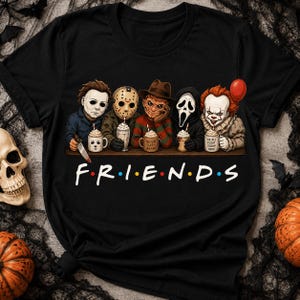May include: A black t-shirt featuring a graphic of five horror movie characters sitting at a table, each holding a mug with whipped cream. Below the characters, the text F.R.I.E.N.D.S is printed in a white font with colourful dots between letters.