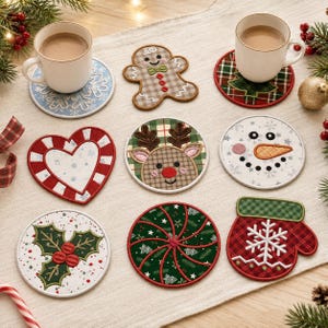 May include: A collection of nine fabric coasters featuring various holiday designs including a gingerbread person, a reindeer, a snowman, a mitten, a heart, holly, and peppermint patterns, arranged on a light-coloured fabric surface.