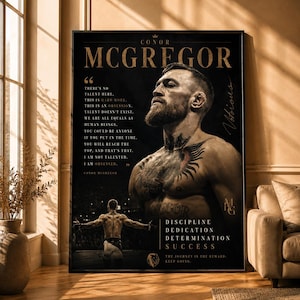 May include: A rectangular wall poster featuring a portrait of Conor McGregor with a beard and chest tattoos. The black background includes gold text with a quote, the name Conor McGregor, and the words Discipline, Dedication, Determination, Success.