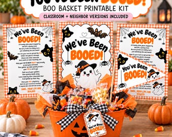 May include: A Halloween boo basket kit featuring an orange oval container with a jack-o'-lantern face, filled with treats and decorated with a black and white gingham bow. Includes printable signs with ghost and bat graphics and the text You've Been Booed.